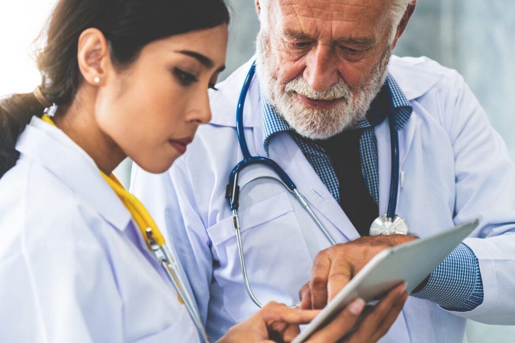 Two healthcare professionals looking at a tablet together
