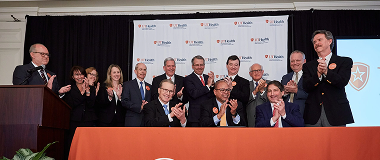 Group of people at UTHealth table for Medical School Grant event