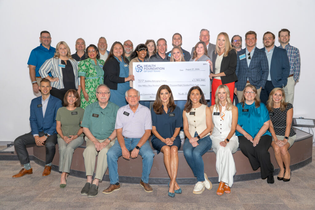 Health Foundation of East Texas Building Belonging funded partners, HFET Board Members and Staff, and RPF reviewers pose with a ceremonial check recognizing HFET’s investment in Youth Resilience.